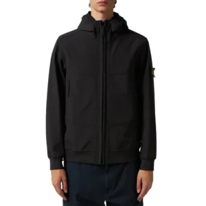The Stone Island Light Soft Shell Black Jacket is made from durable polyester, featuring a hooded collar and ribbed knit cuffs for a comfortable and secure fit. With a front zip closure and sleek black design, this lightweight jacket is perfect for casual wear, outdoor activities, or layering in cooler weather, combining style and functionality effortlessly.